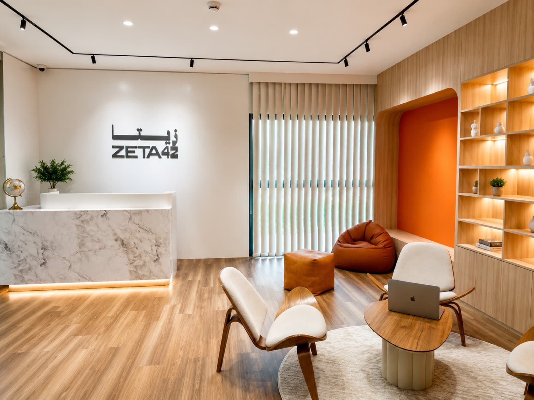 Zeta42 reception with marble front desk, lounge seating, and the Zeta42 logo