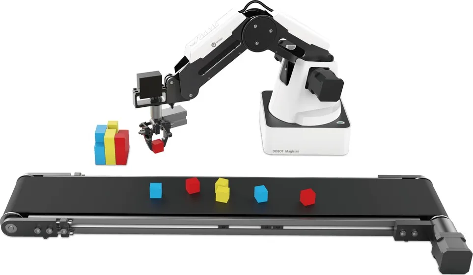 A desktop arm above a short conveyor carrying coloured blocks
