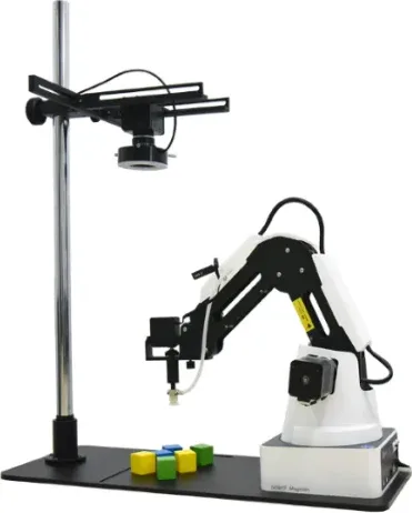 A desktop arm beside a camera on a stand, with coloured blocks laid out in front of it