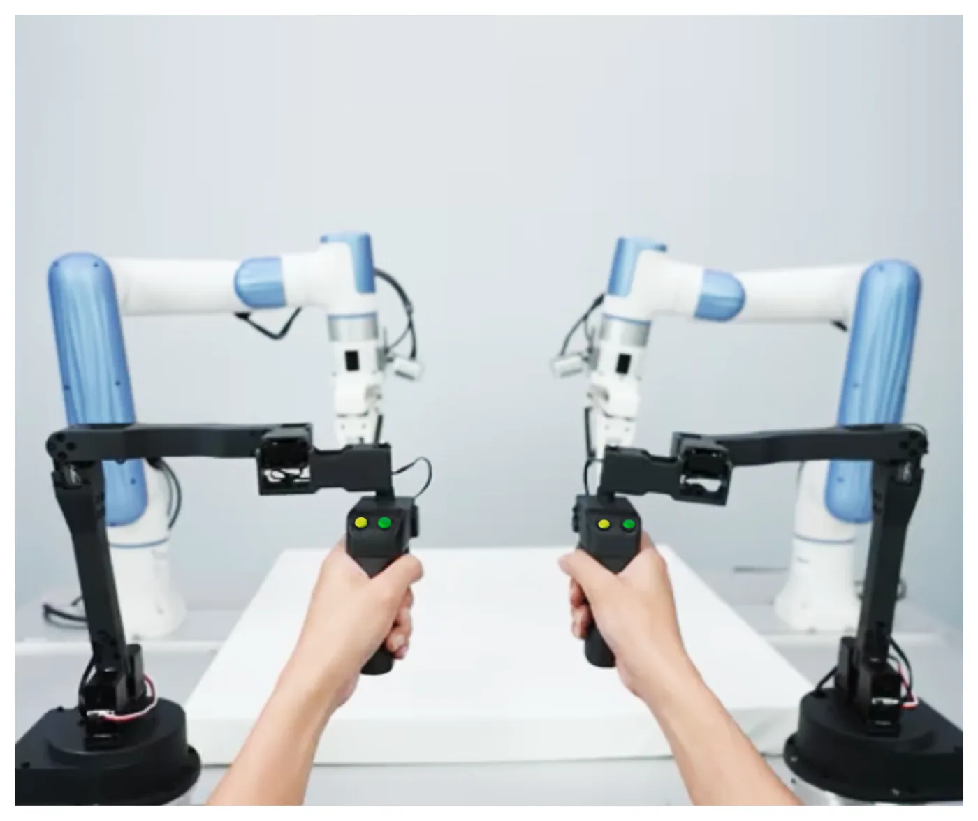Two arms facing each other while a person works a control grip in each hand